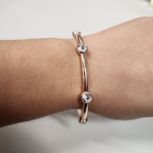 Rose Gold-Tone Bangle Bracelet with Spaced Station Clear Rhinestones